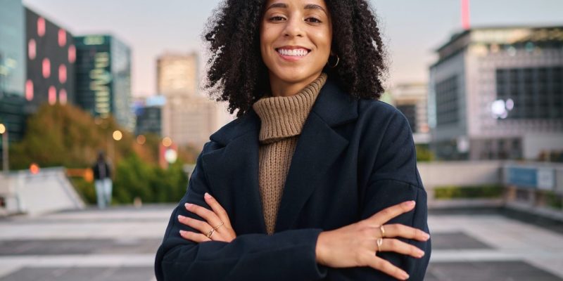 black-woman-portrait-smile-and-arms-crossed-in-the-city-for-vision-ambition-or-career-success-co.jpg